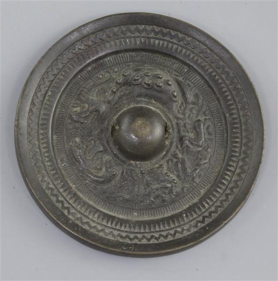 A small Chinese bronze circular mirror, Tang dynasty, 7th-9th century A.D., 10cm diameter, curved split